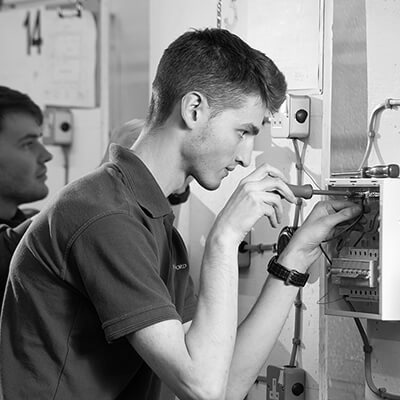 Students working on test electrical equipment