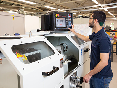 Machinist apprentice using CNC machine