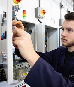 Engineering apprentice working on electrical installation
