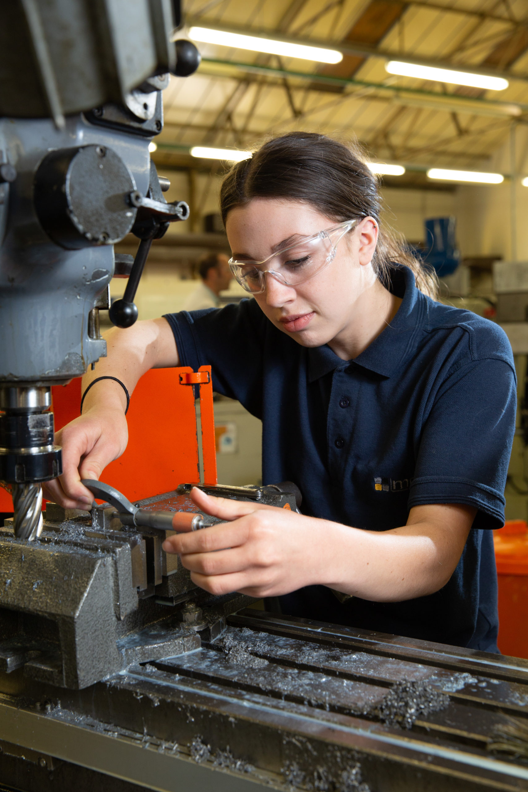 Engineering apprentice inspecting a machined part