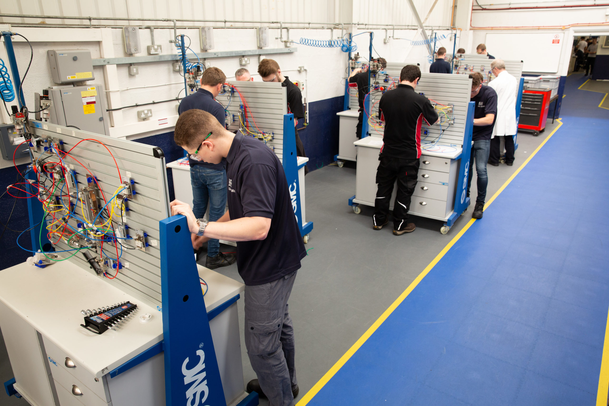 Mechatronics Maintenance Technician apprentices in workshop doing Pneumatic circuit building