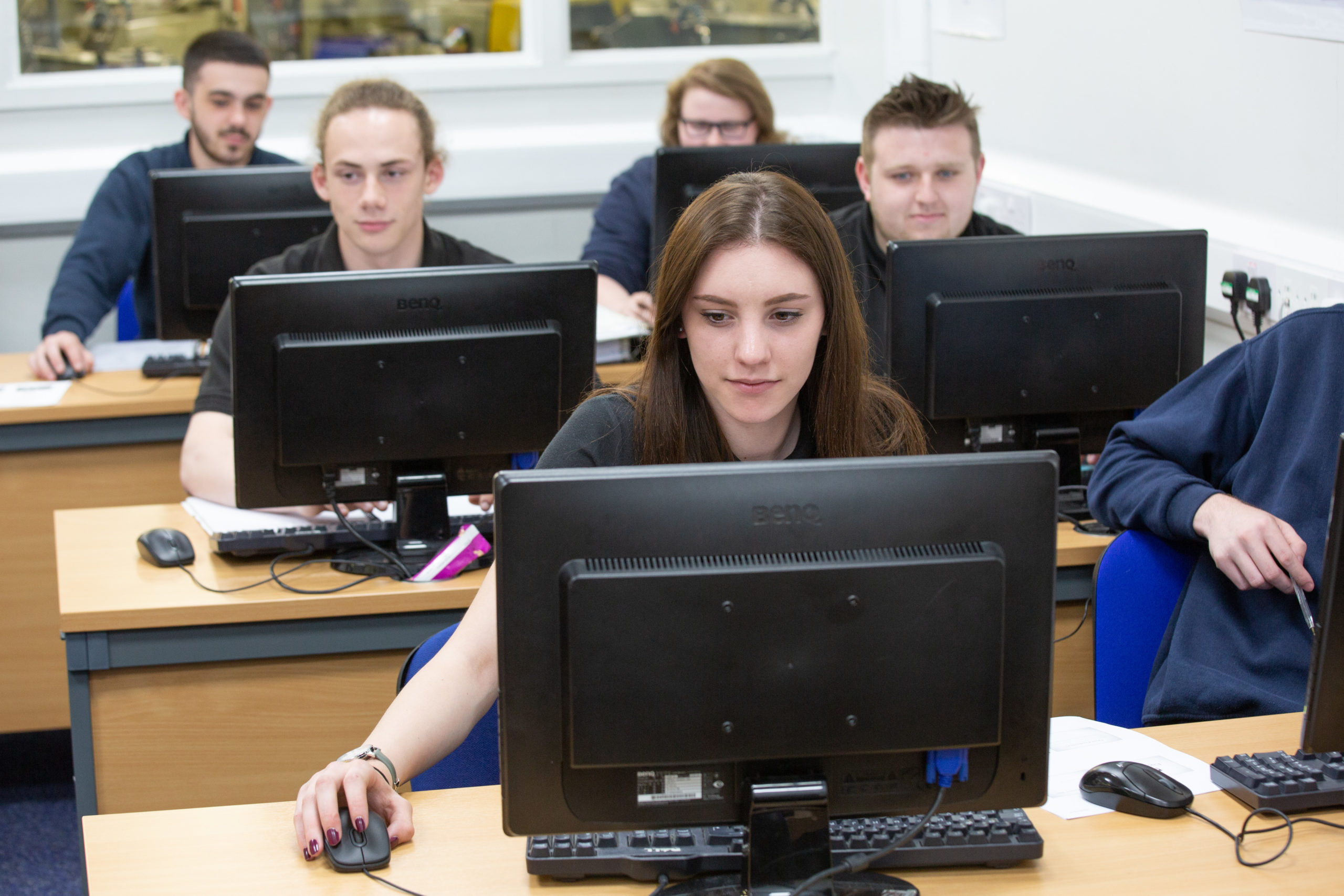 Apprentices using computers doing coursework