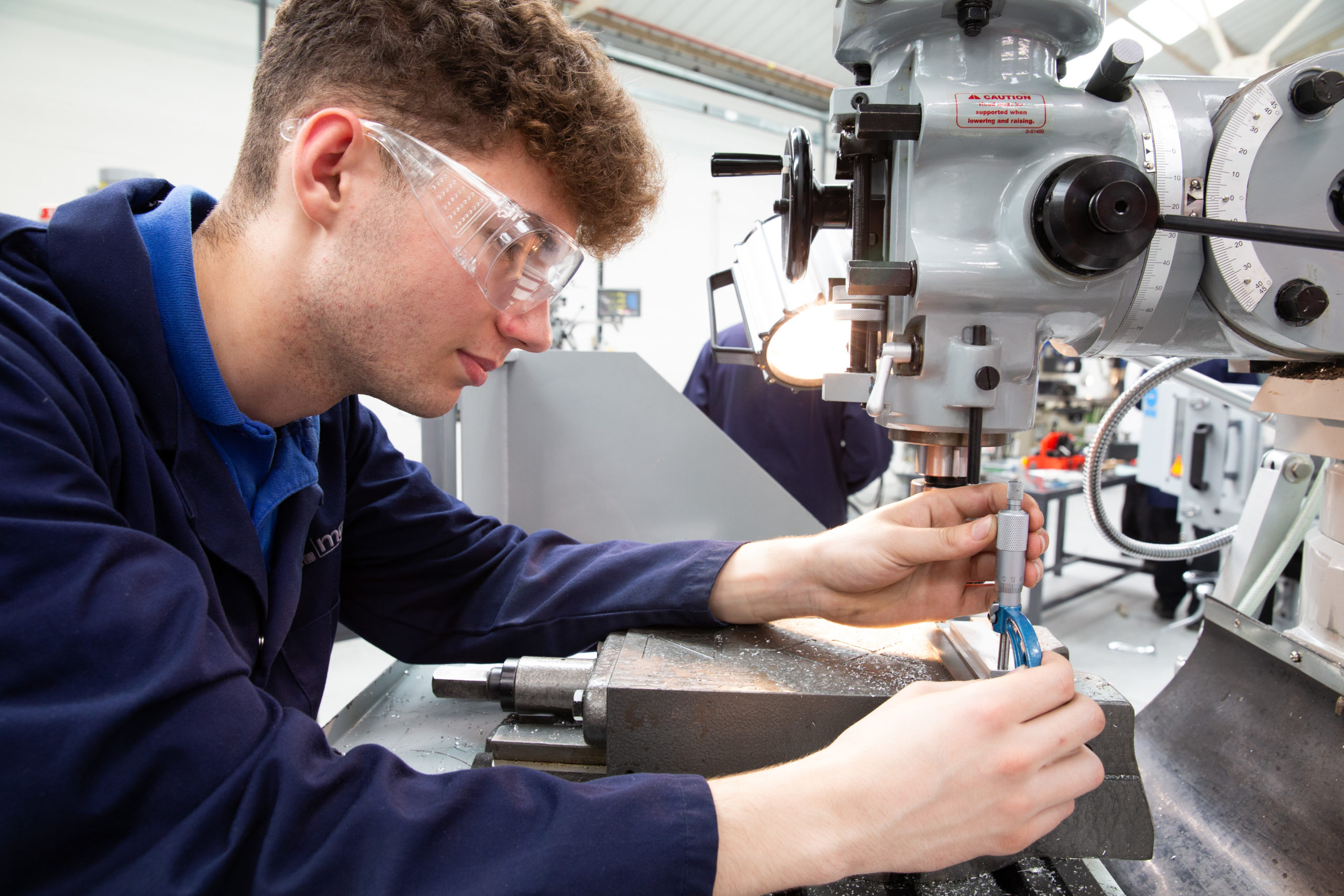 Toolmaker and Tool & Die Maintenance Technician apprentice inspecting a machined component