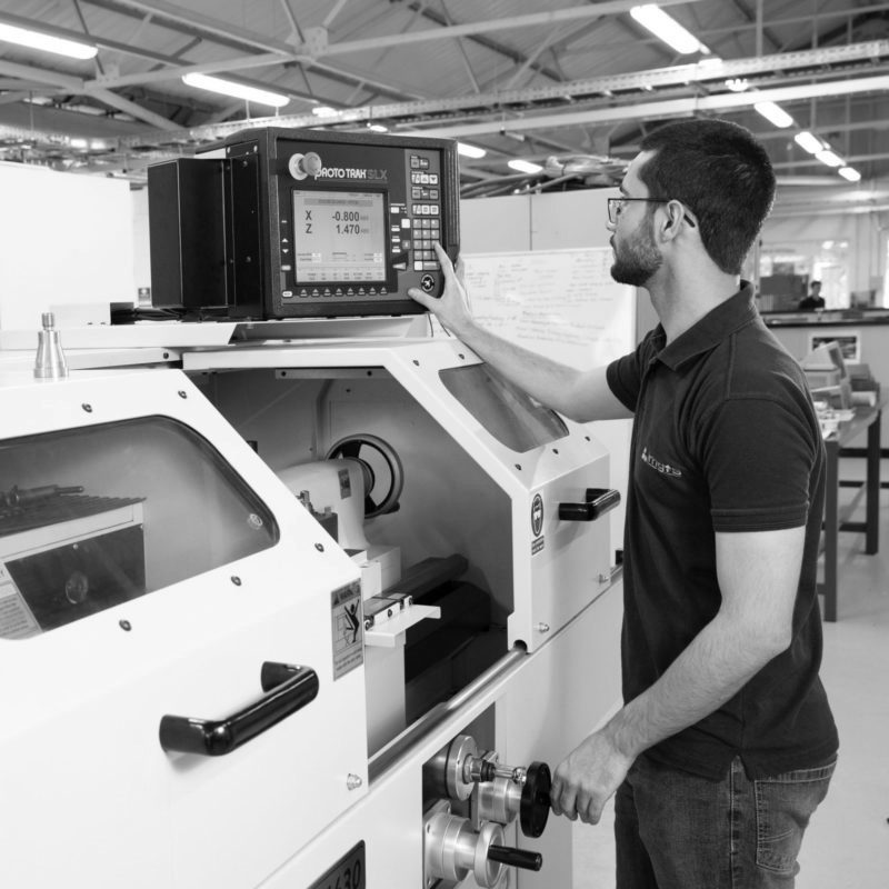 Machinist apprentice using CNC machine