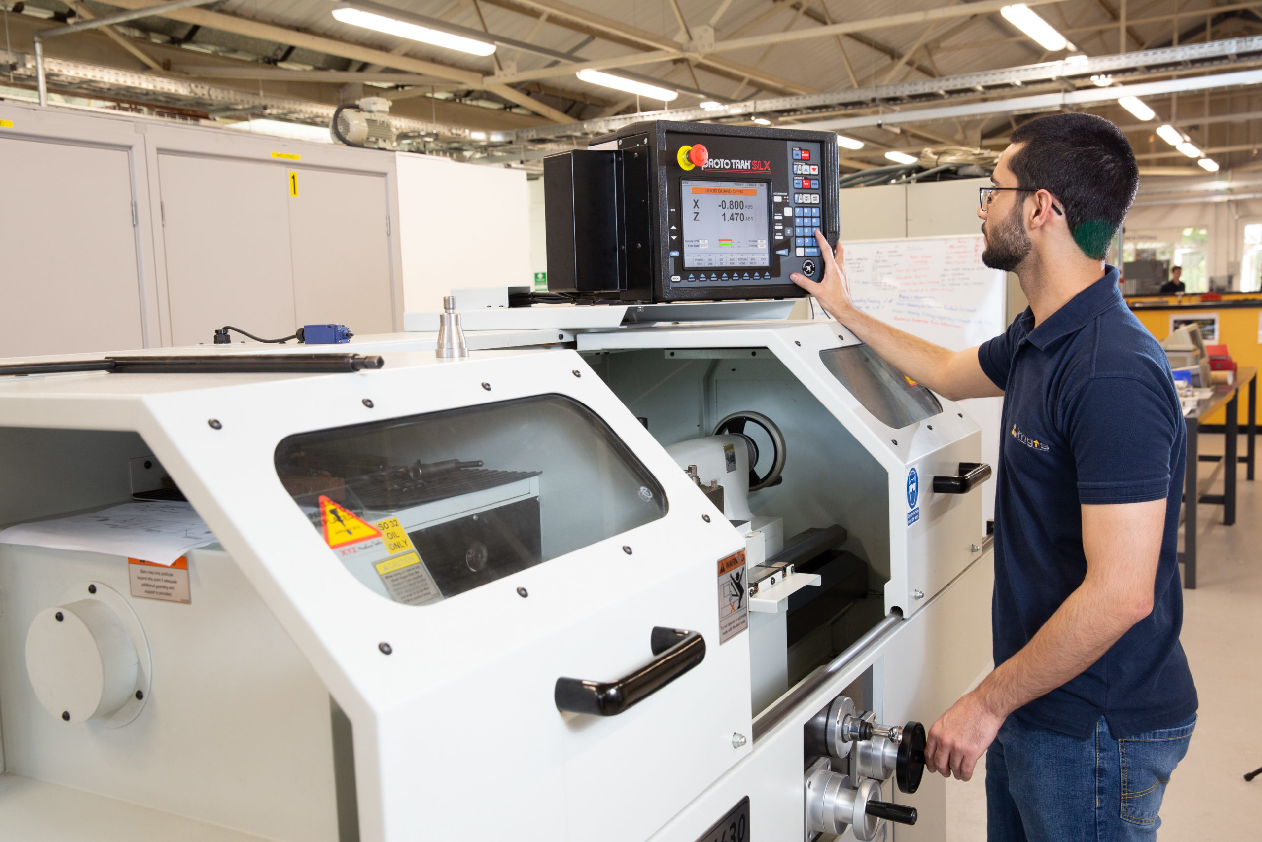 Machinist apprentice using CNC machine