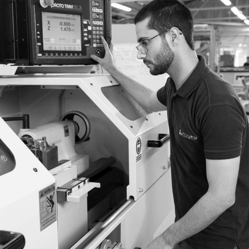 Machinist apprentice using CNC Machine