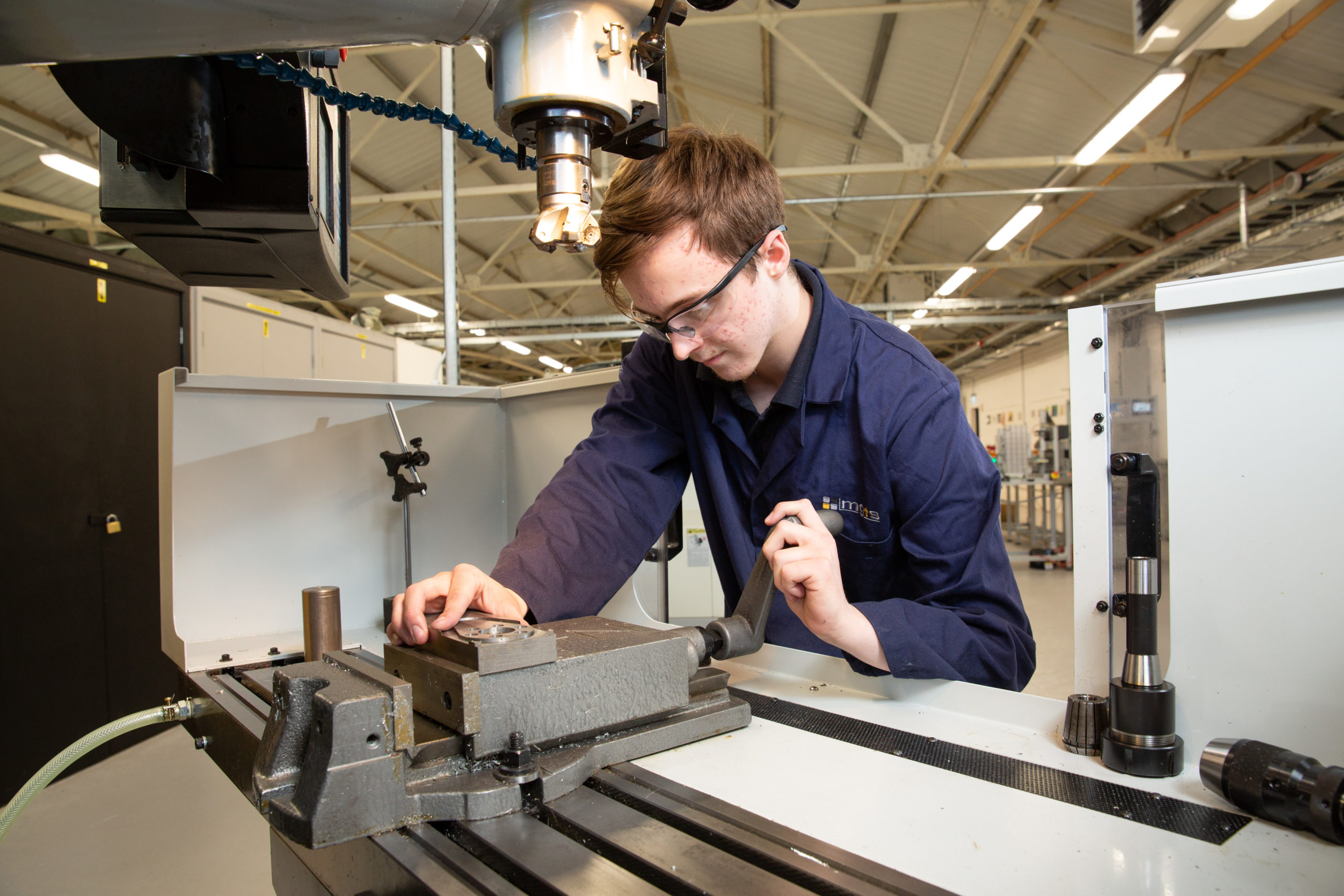 Machinist apprentice setting vice on a milling machine