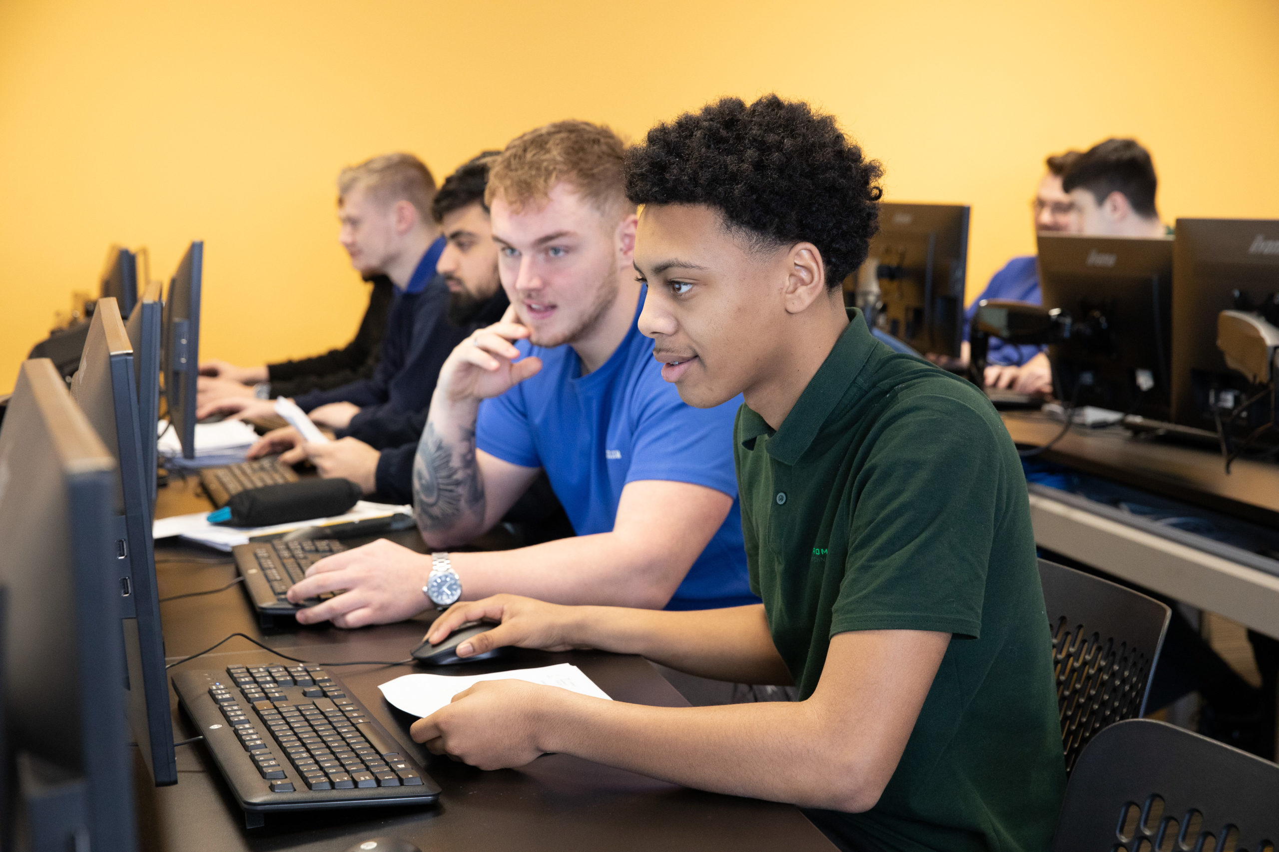 Two engineering apprentice working on computer