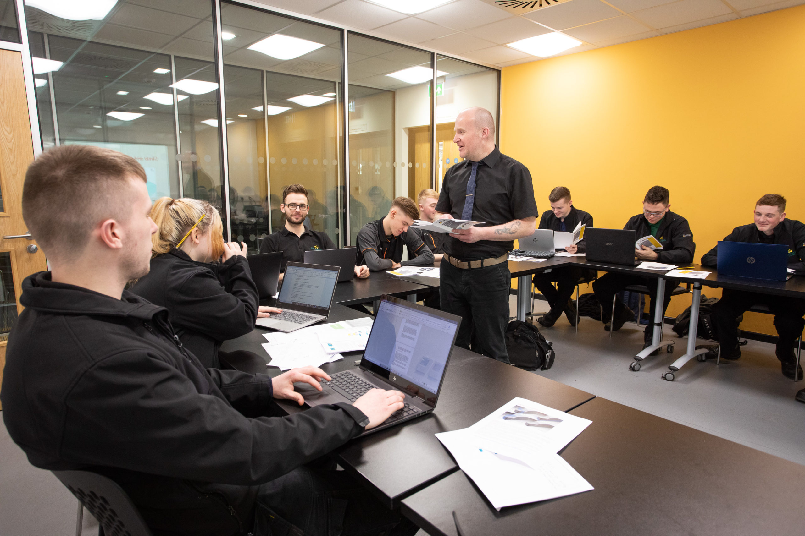 Man teaching Food and Drink Engineering Maintenance Technician apprentices in classroom