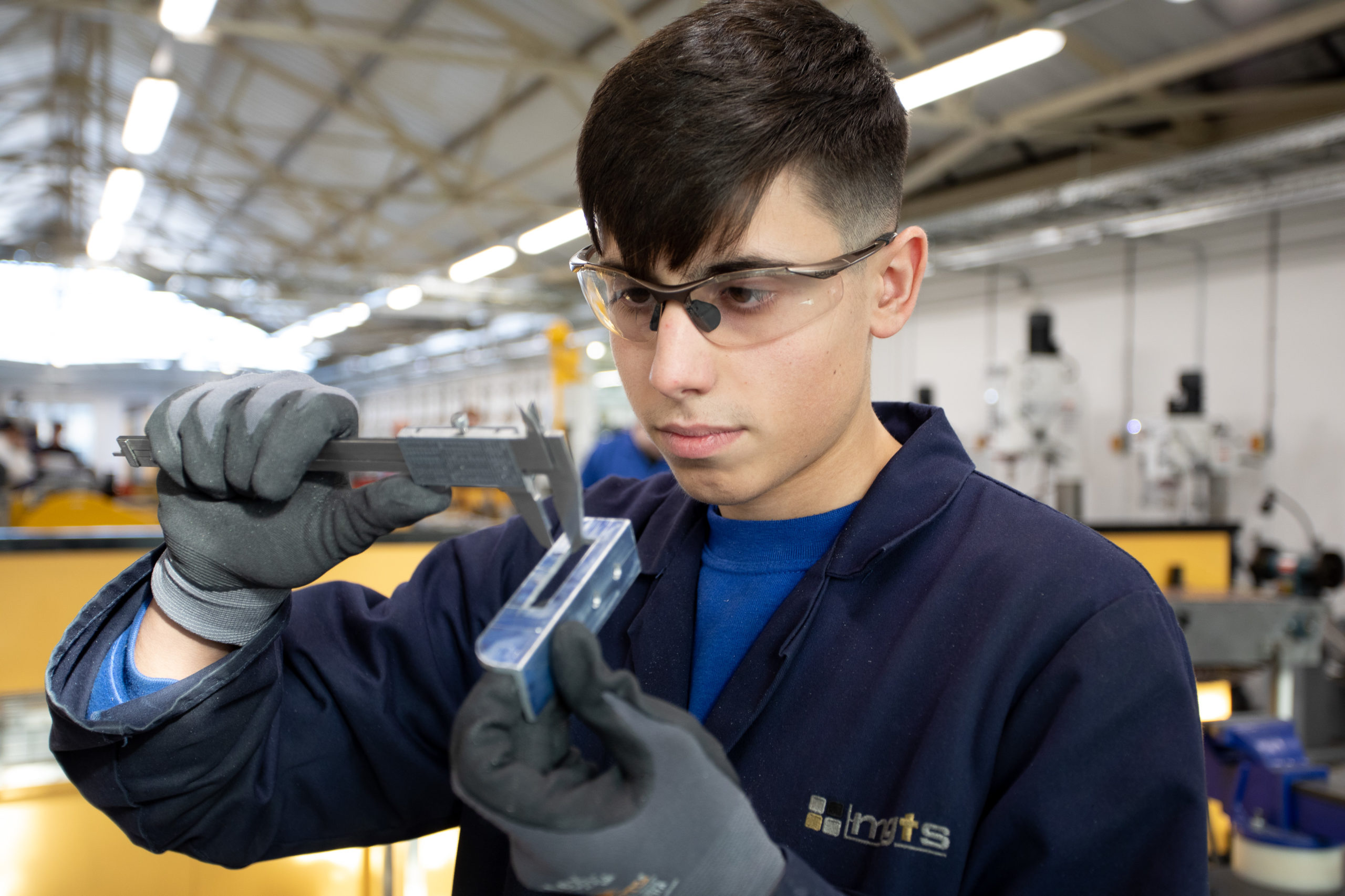 Product Design & Development Technician apprentice inspecting fitting