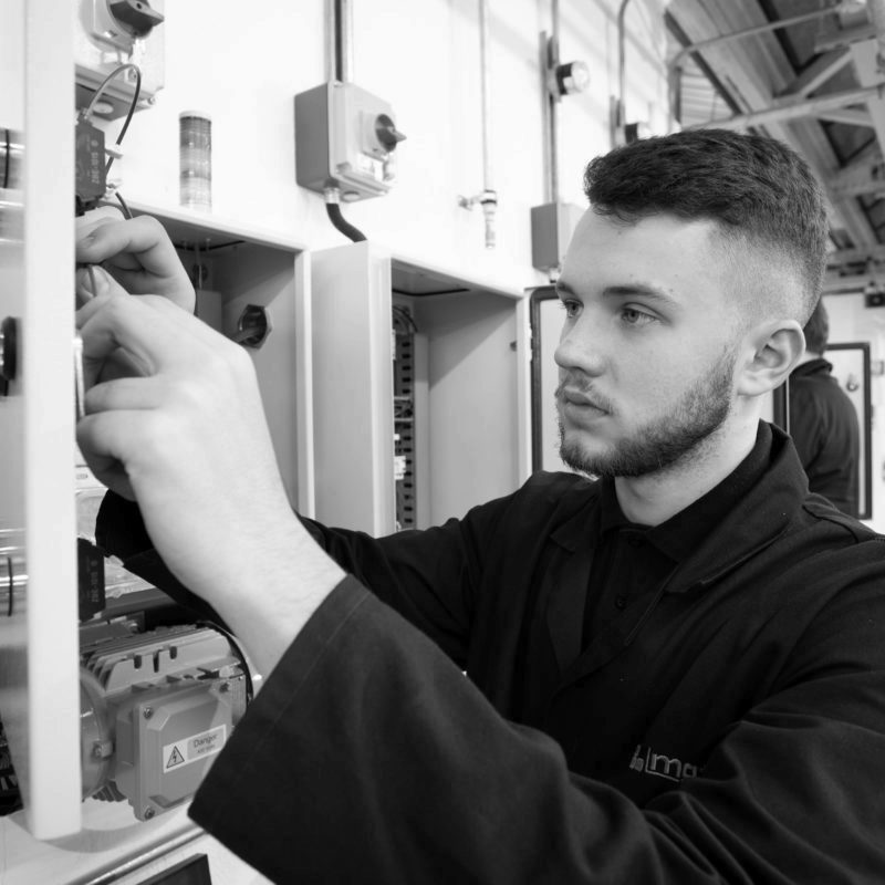 Engineering apprentice working on electrical installation