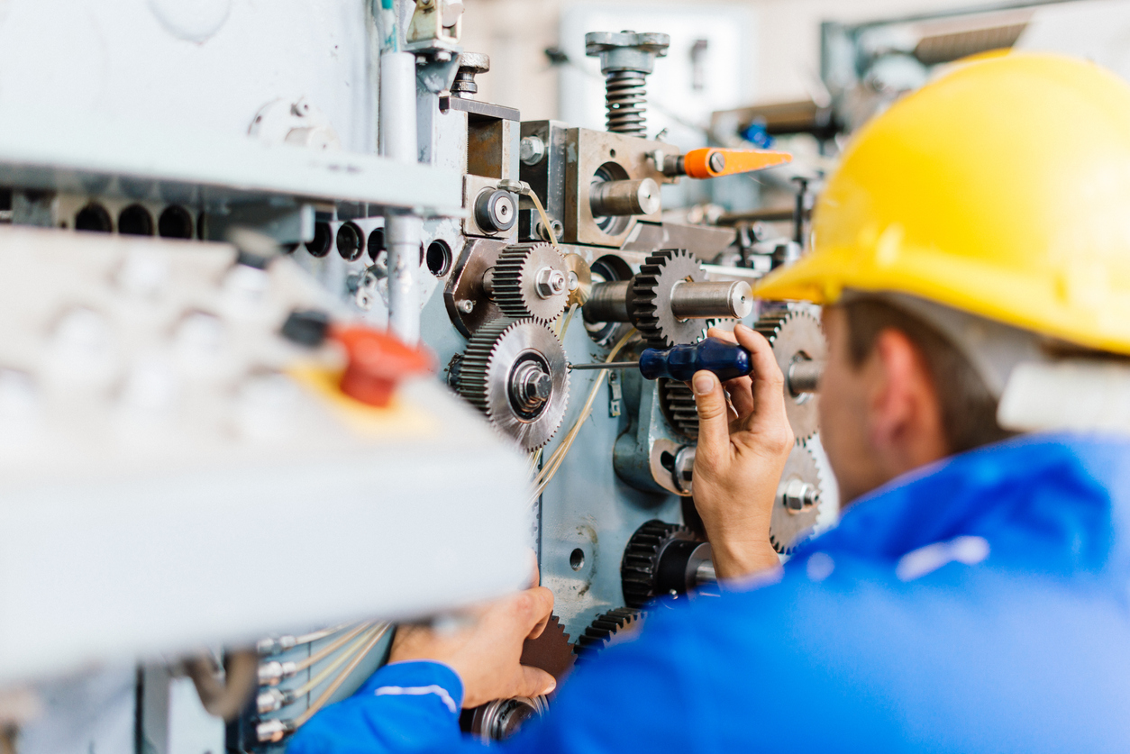 Maintenance engineer in factory installing the engine